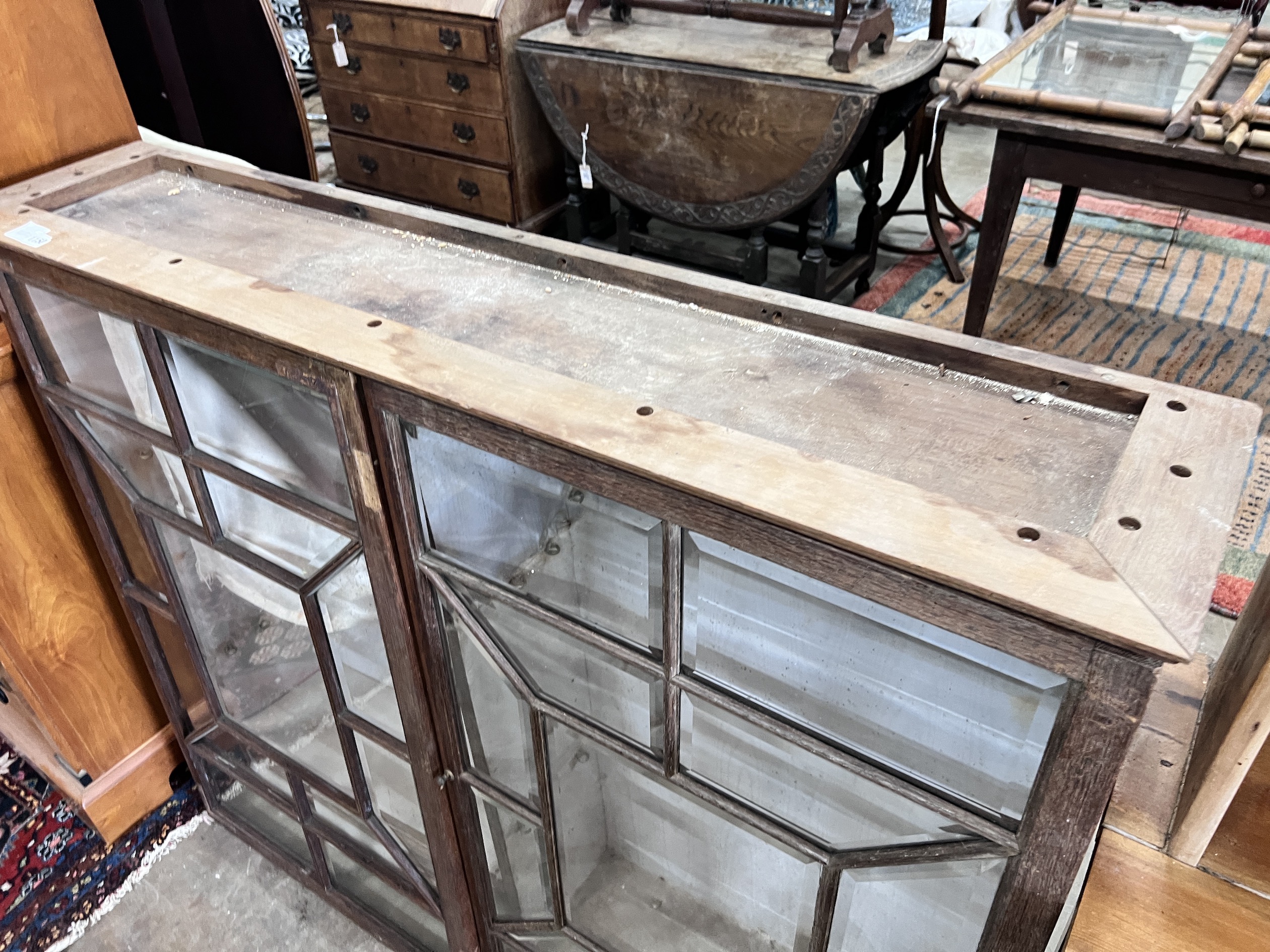 A George III style oak bookcase section, length 130cm, depth 27cm, height 110cm